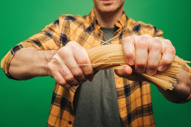 close-up-young-man-strongly-breaks-spaghetti_341052-1634.jpg